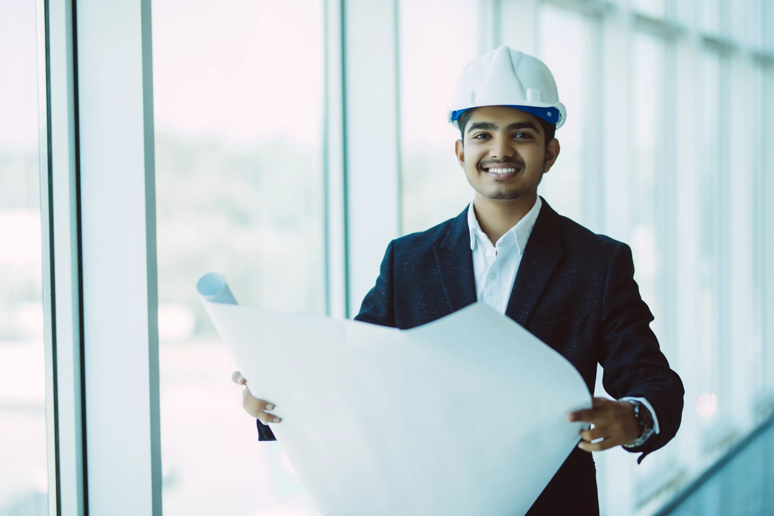 Indian Architect or engineer at work on a building site.